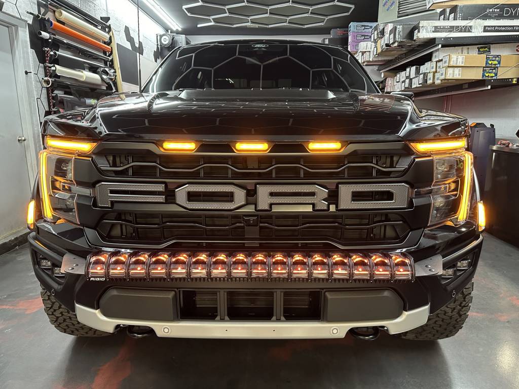Close-up of custom LED headlights on electric vehicle during detailing