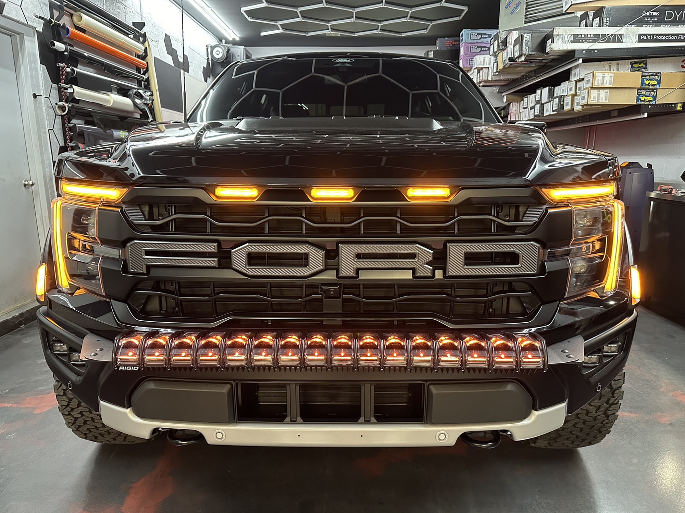 Close-up of custom LED headlights on electric vehicle during detailing