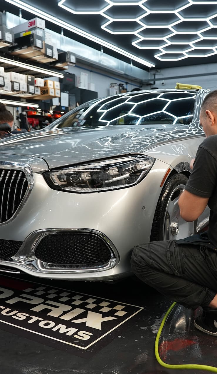 erfecting STEK Clear Bra Edges – Grand Prix Customs NYC Close-up of STEK clear bra edge wrapping during PPF installation at Grand Prix Customs NYC